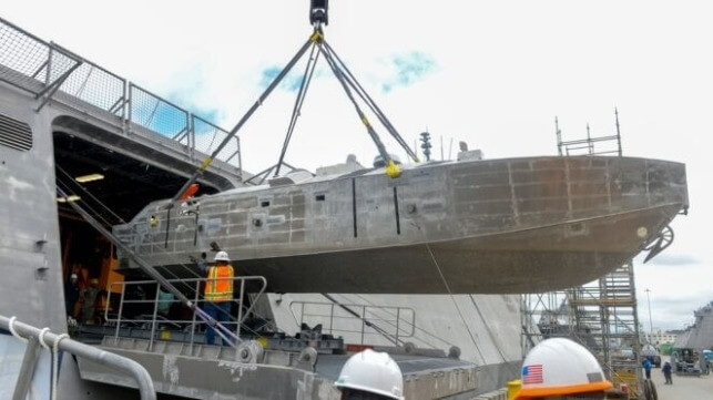 An unmanned surface vehicle is craned aboard the Independence-variant littoral combat ship USS Canberra (LCS 30), as a part of the first embarkation of the Mine Countermeasures (MCM) mission package.