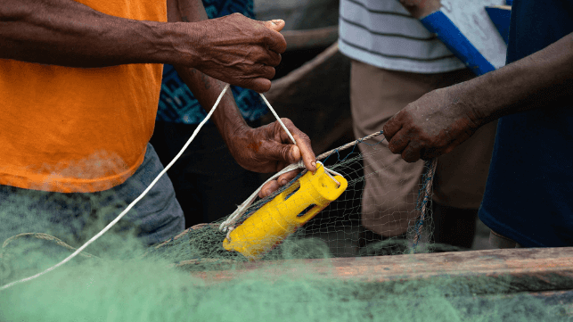 A fisher attaching a temperature and depth sensor to his fishing net in Ghana (Ocean Data Network, Environmental Defense Fund, Partnership for Observation of the Global Ocean, and the University of Ghana)