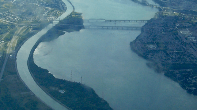 The separate seaway navigation channel (left) near Montreal (public domain)